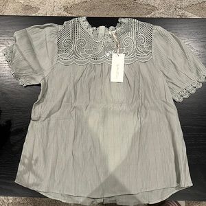 Very cute top. Textured, lightweight with adorable lace detailing,